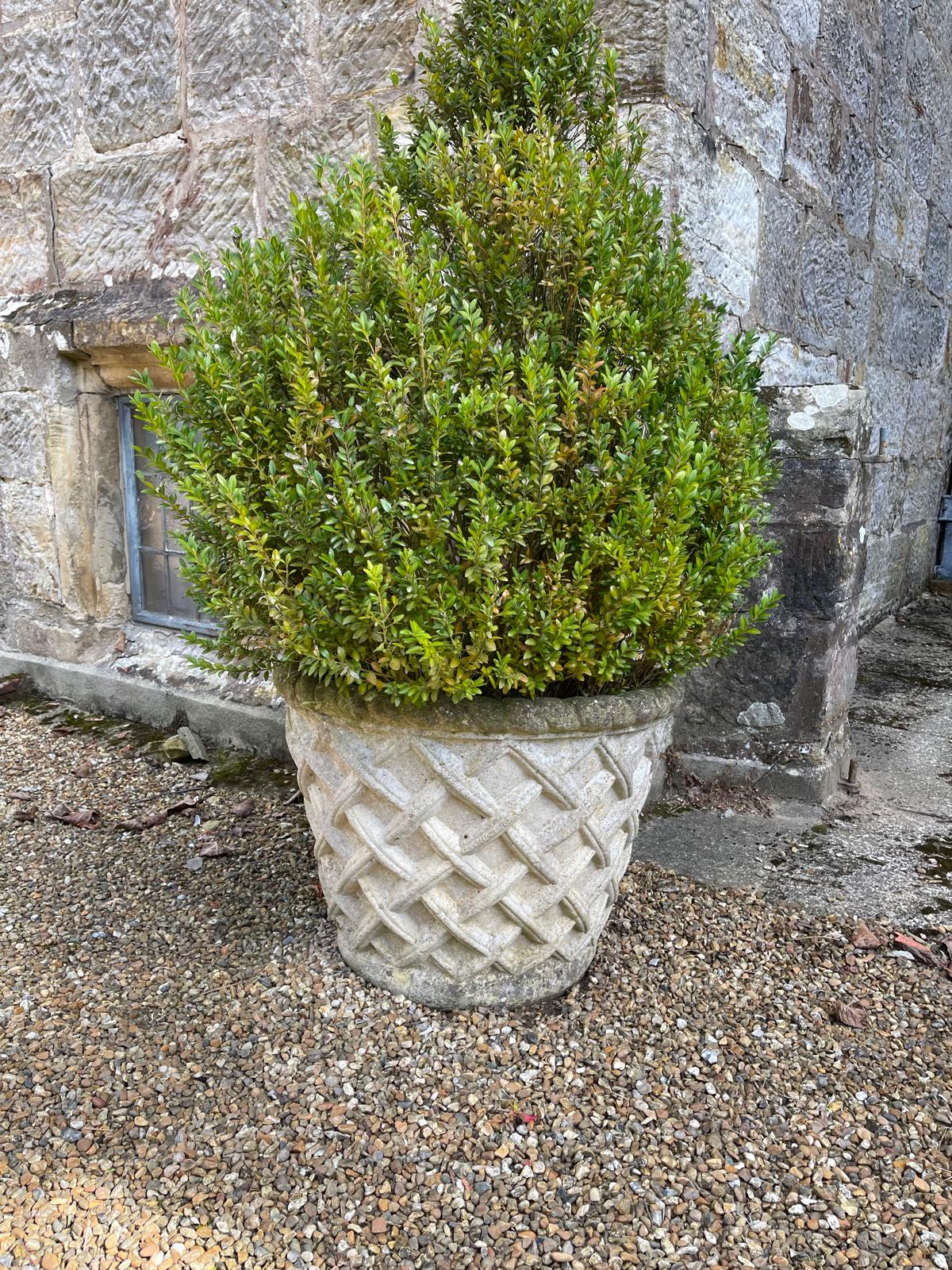 A set of four reconstituted stone garden vases